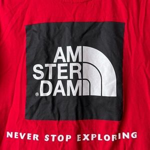 Amsterdam “Never Stop Exploring” red tee